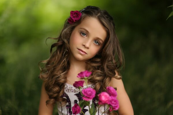 Portrait d une jeune fille avec des roses sur fond de feuillage