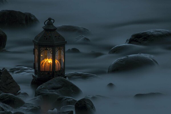 A forgotten lighted lantern on the shore