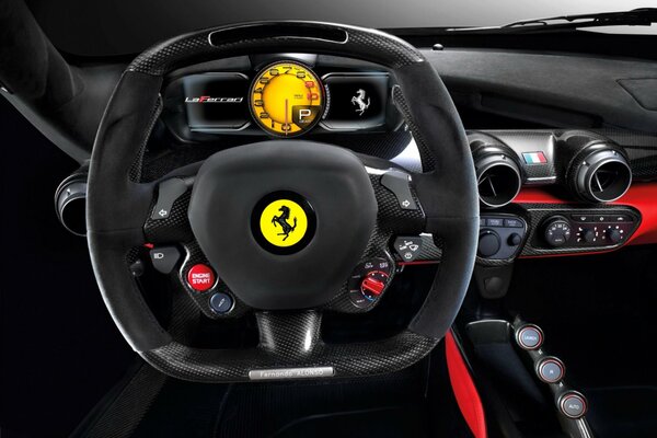 The control panel with the steering wheel of a ferrari car