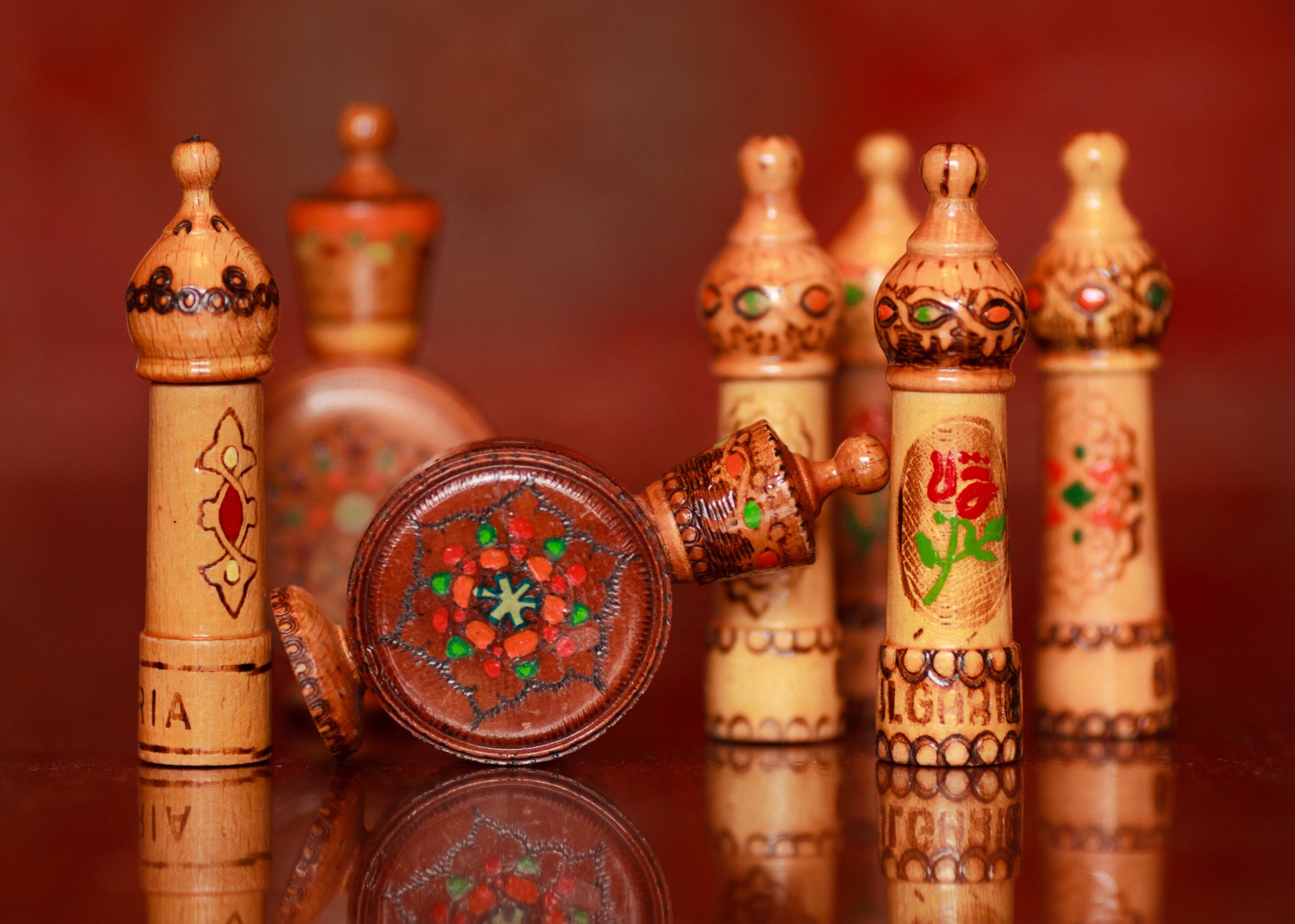 wooden soothers figures lighters bulgarian rose oil reflection background