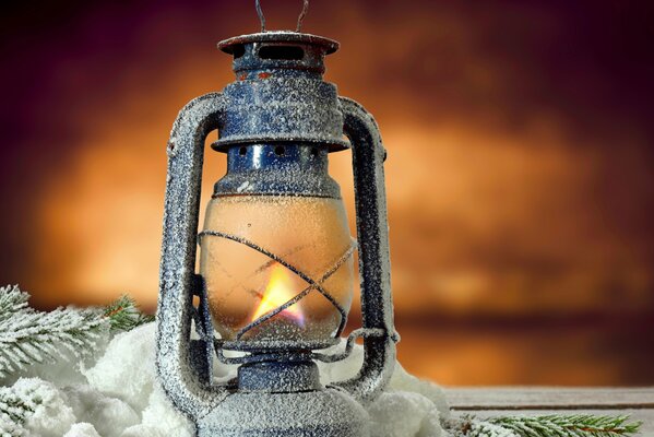 Antique lamp on a snow-covered table
