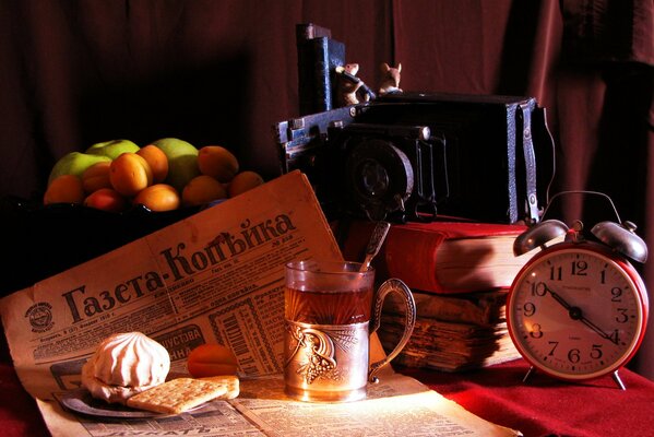 Vintage alarm clock, cup holder, newspaper