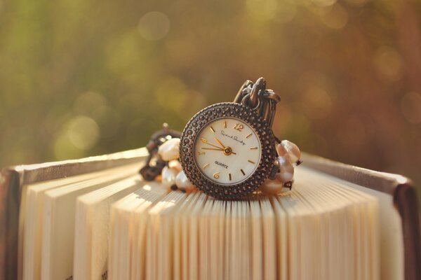 Vintage watch on a chain , blurred background