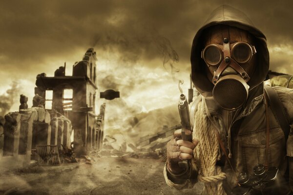 A man stands in a gas mask with a hood on the background of a destroyed city