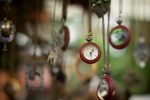 Eine Uhr an einer Kette hängt vor einem unscharfen Hintergrund