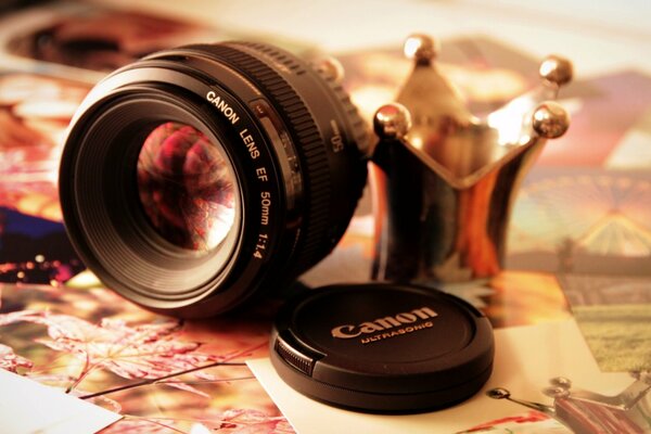 Canon lens and cover on the background of photos