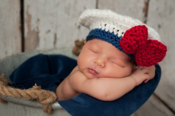 A child in a knitted beret with a red bow