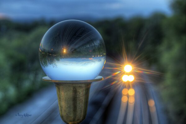 A glass ball on a pole in front of the train