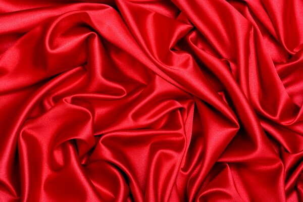 Photo of the folds of red fabric. Silk