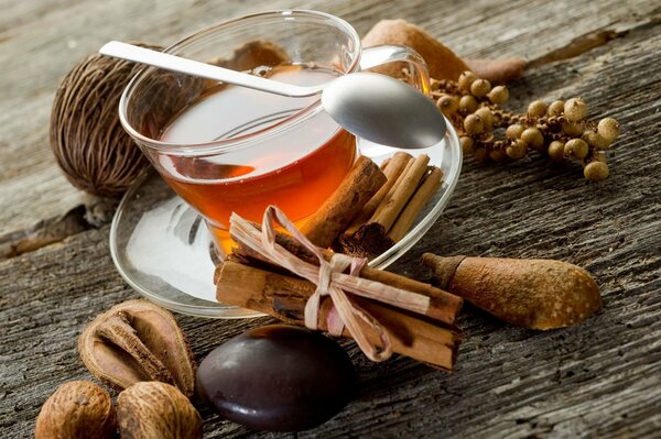 A mug of tea with cinnamon on a tree background