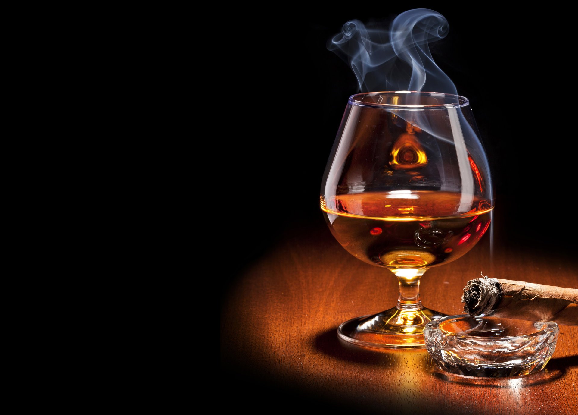 brandy glass cigar smoke black background