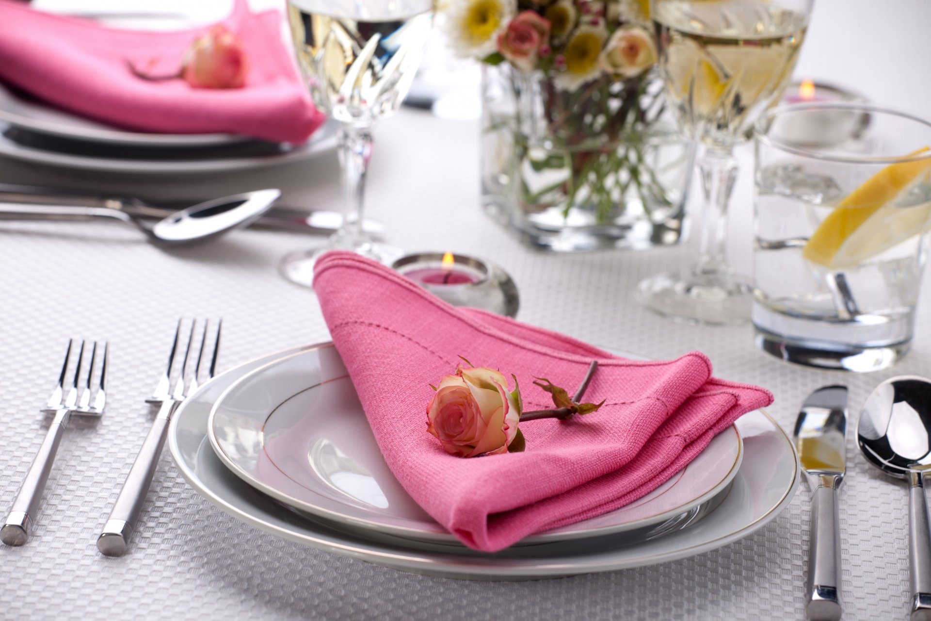 erving table rose flower napkin plates cutlery knives forks candle glasses glasse