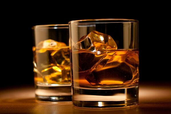 Image sur la table sont deux verres de glace et de whisky