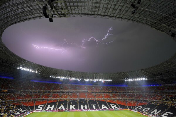 A football match in the open sky and a thunderstorm