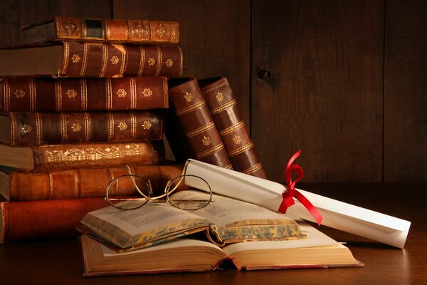 Open books on the table and glasses