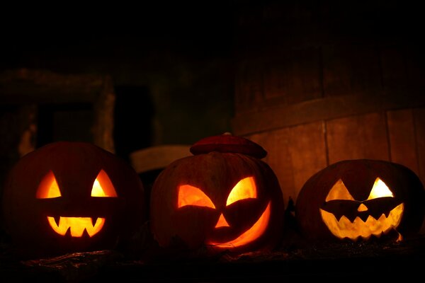 Pumpkins with carved eyes with candles inside