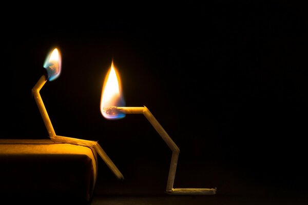 Photo of burning matches on a black background