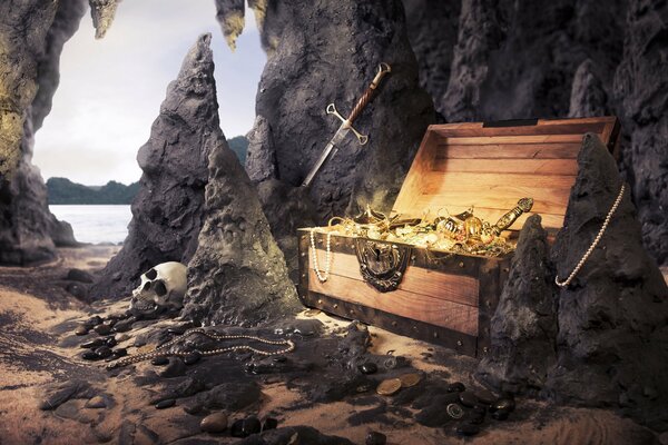 A chest with gold on a background of rocks and a skull