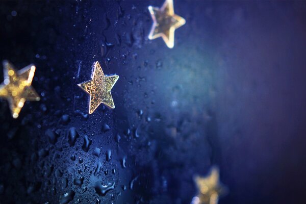 Stars with water drops on a blue background