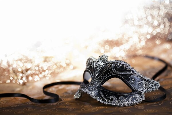 Black and white carnival mask in gold sequins