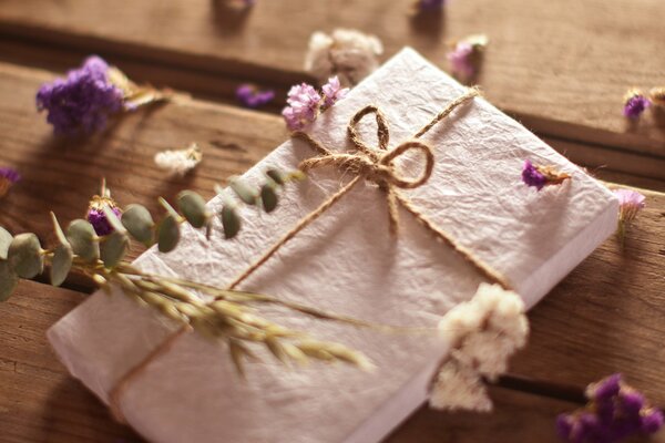 Envelope in flowers on a wooden table