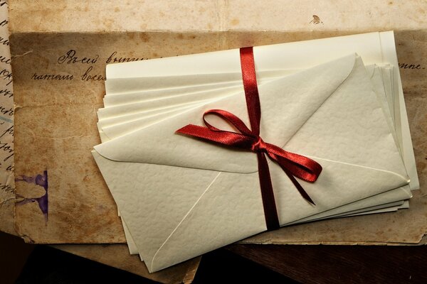 A stack of envelopes with letters on the table