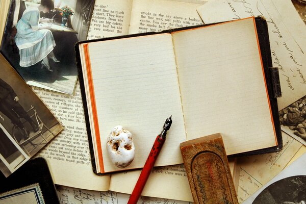 Vintage composition of a notebook, pen and photos