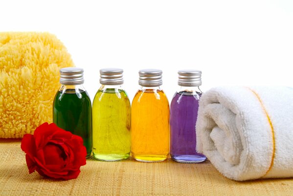 Spa products of bright colors in bottles with towels