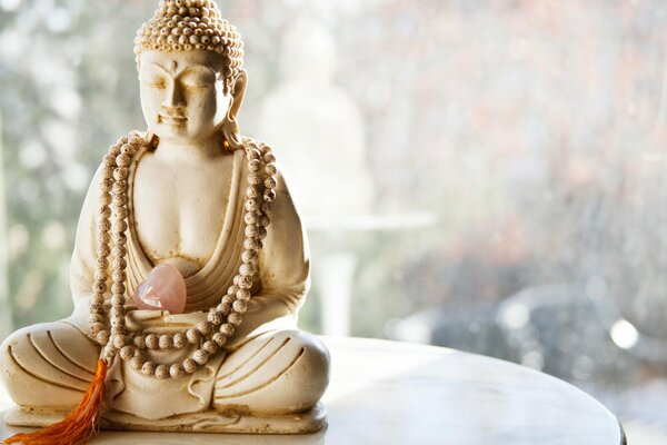 Buddha figurine with a heart made of stone