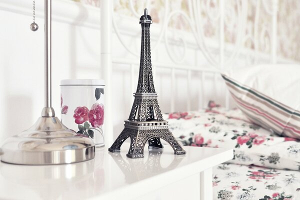 A statuette of the Eiffel Tower on the table