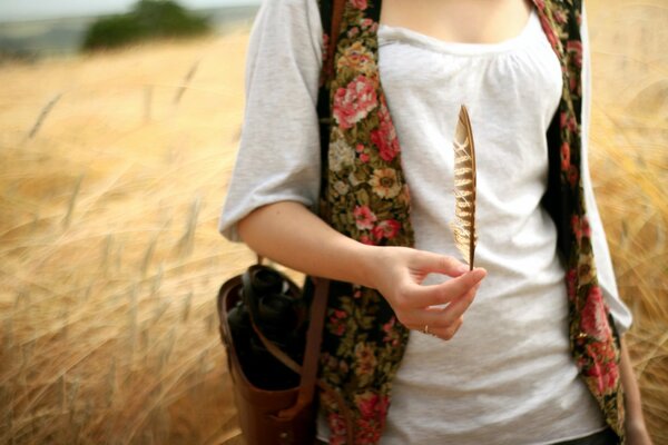 Stray girl with a feather on the field