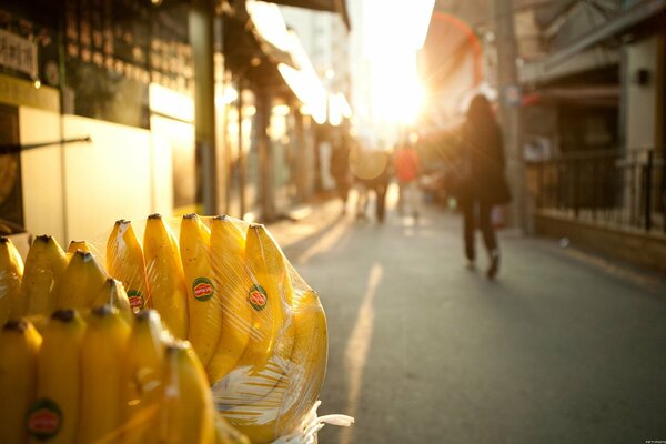 Packed bananas in the foreground of the street