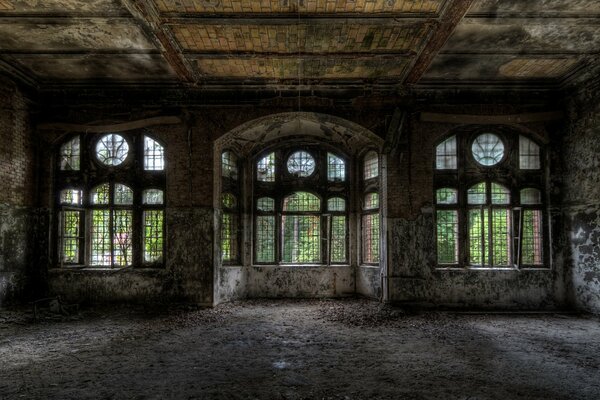 An old abandoned building with large windows