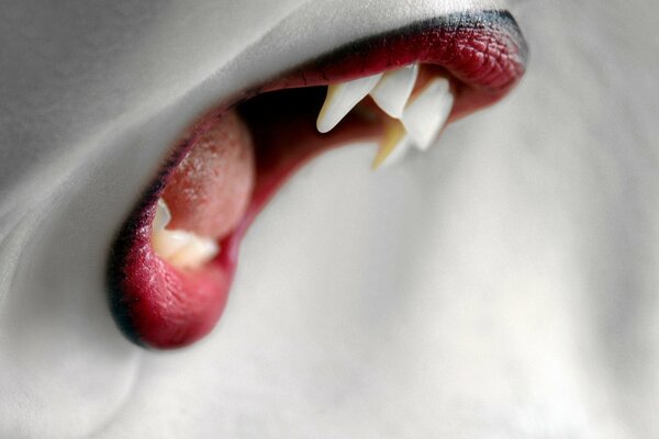 Image of a vampire tooth in red lipstick