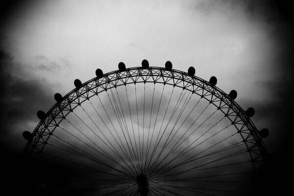 Ferris wheel on a dark sky background. Black and white