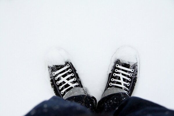 Snow-covered shoes of a young man