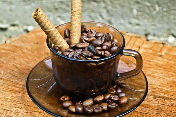 A saucer of coffee beans and cinnamon