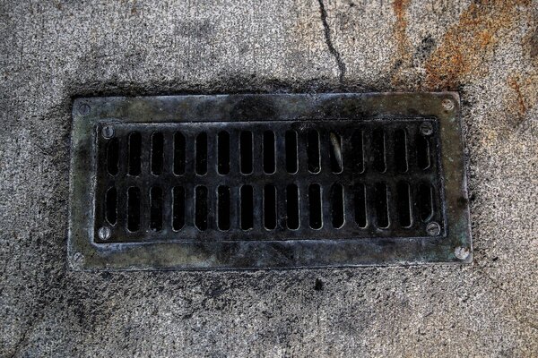 Sewer grate on an asphalt road