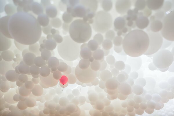 A red ball looms among the white balls