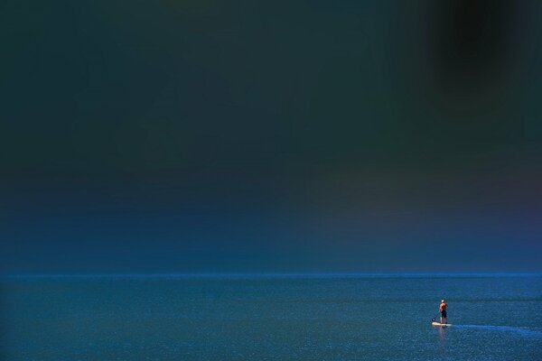 A man on a board in the sea alone