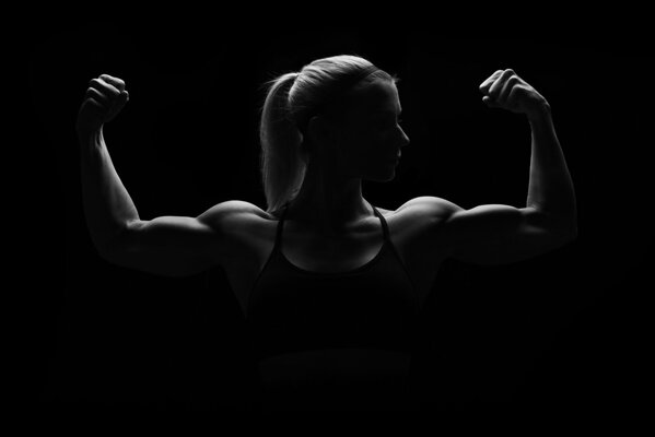 Silhouette of a strong woman with muscles