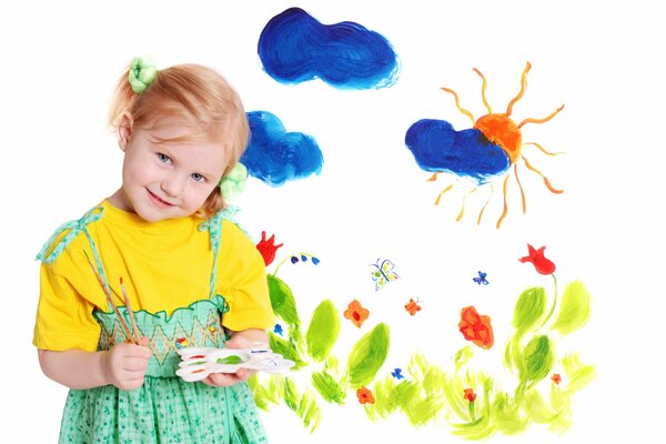 A little girl draws blue clouds