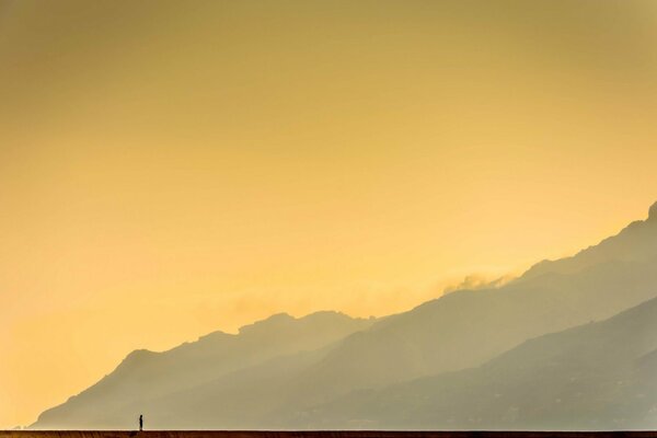 The figure of a man on the background of mountains