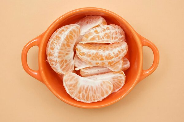 A cup of peeled orange tangerine slices