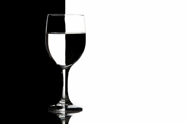 Black and white image of a glass with a clear liquid