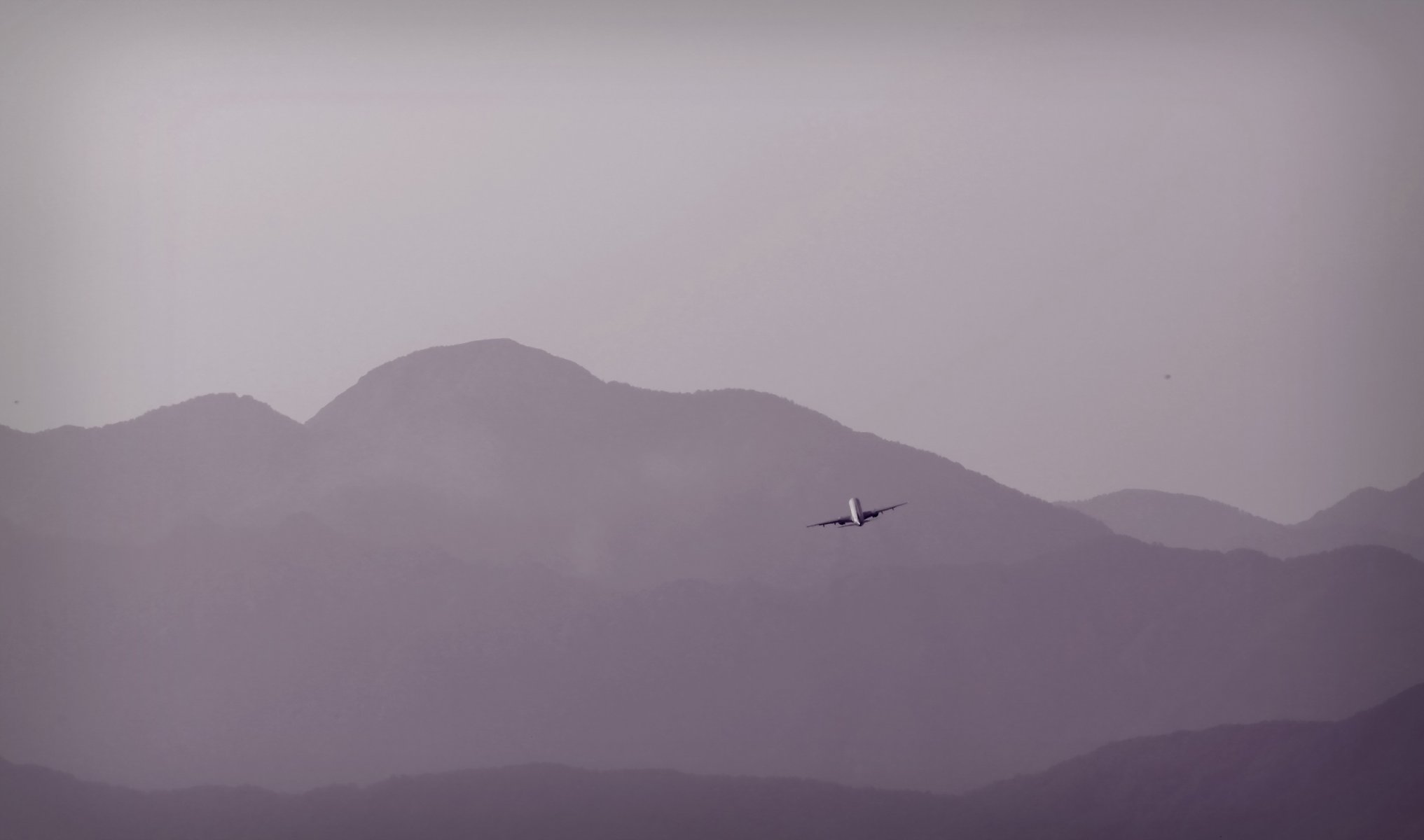 plane mountain sky