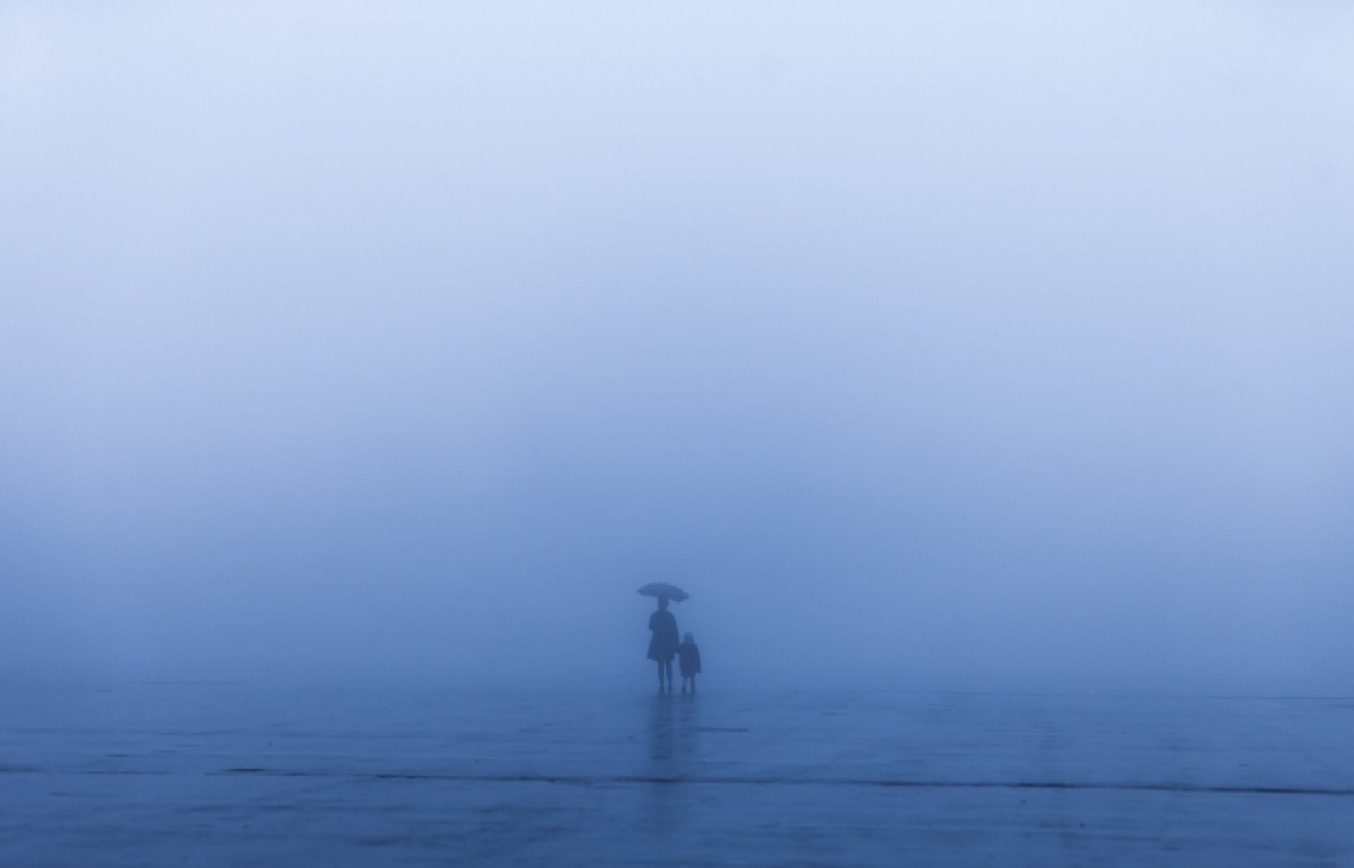 a woman child umbrella storm