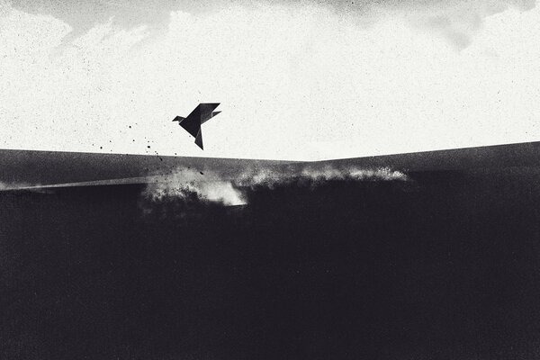 A paper bird flies over a field