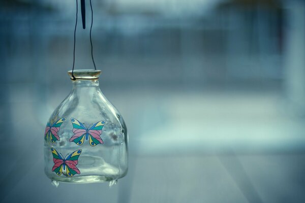 The jar is transparent with different butterflies