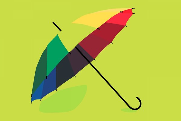 Umbrella in rainbow color on a green background